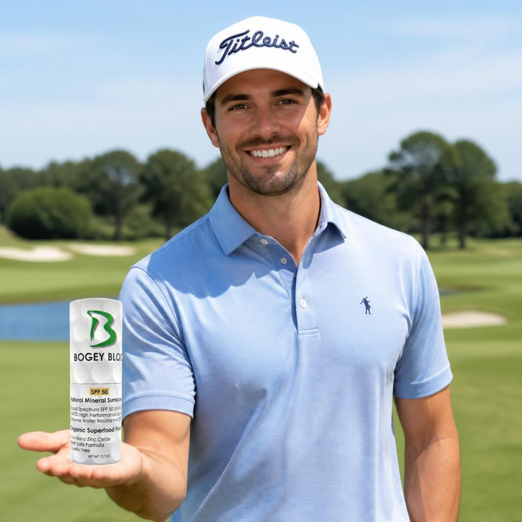 A smiling man on a golf course wearing a white Titleist cap and a light blue polo shirt, holding up a bottle of BCGEY Bio golf club care product.